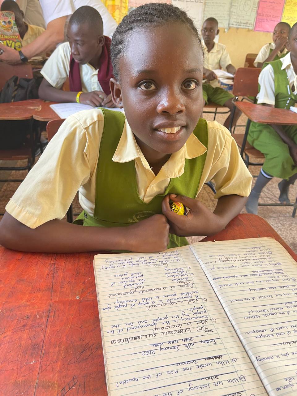 A Maisha student writing at their desk